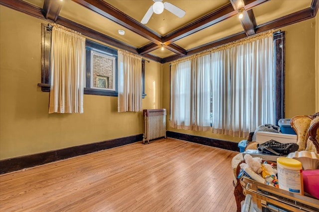 miscellaneous room featuring coffered ceiling, ceiling fan, ornamental molding, radiator heating unit, and beam ceiling