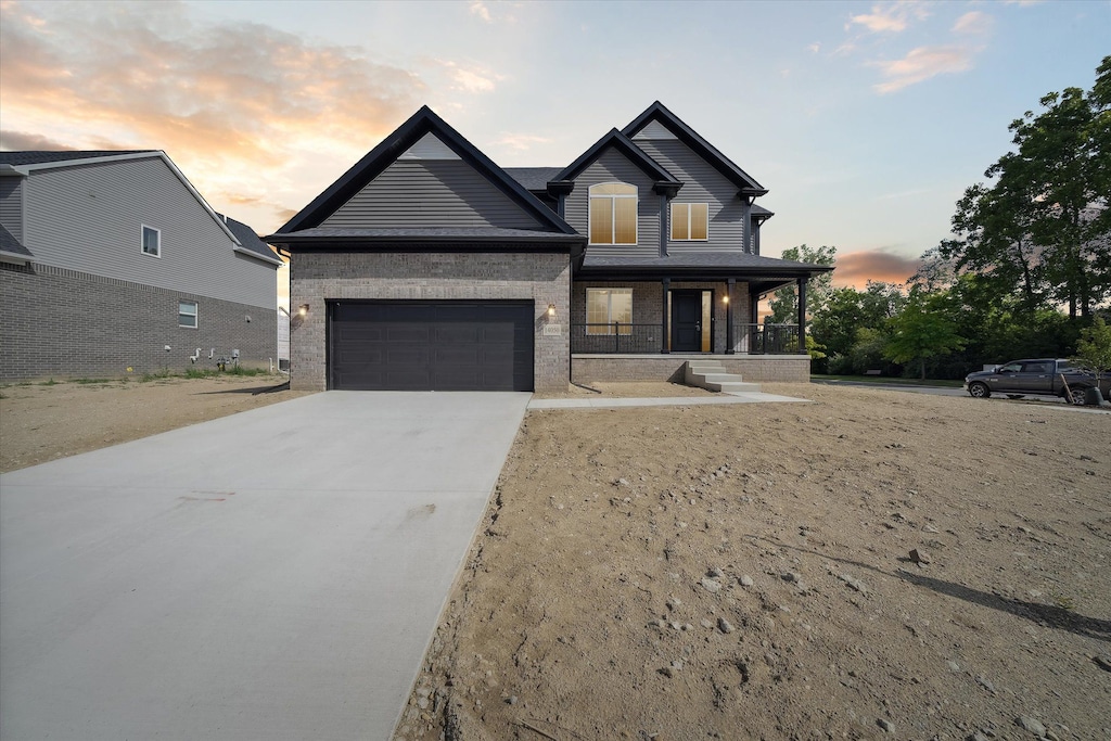 view of front of house with covered porch and a garage