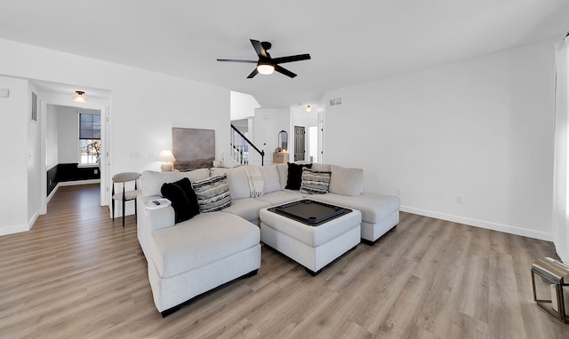 living room featuring ceiling fan and light hardwood / wood-style floors