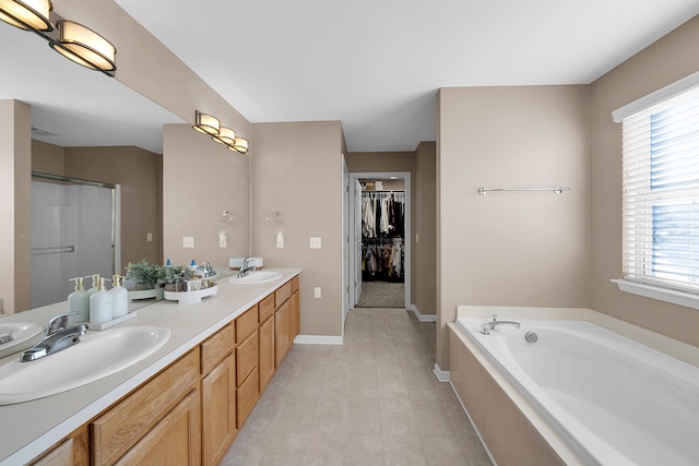 bathroom featuring vanity and independent shower and bath