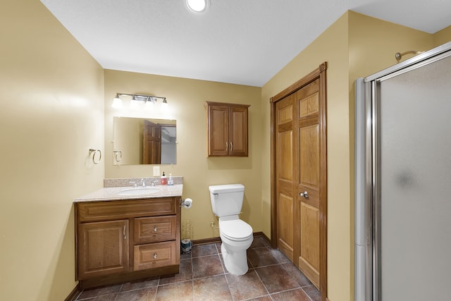 bathroom with vanity, toilet, and walk in shower