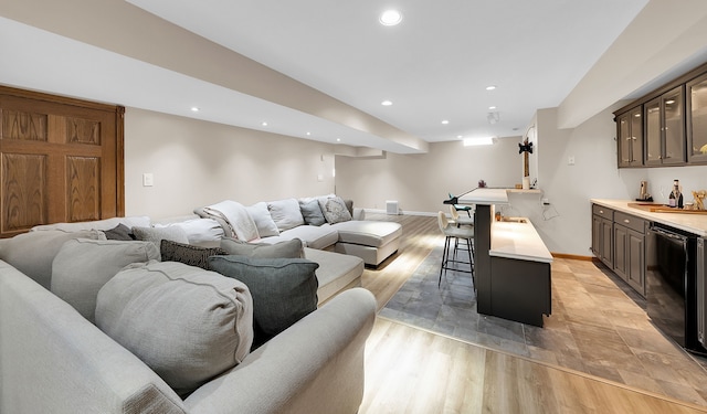 living room featuring light hardwood / wood-style floors, wine cooler, and indoor bar