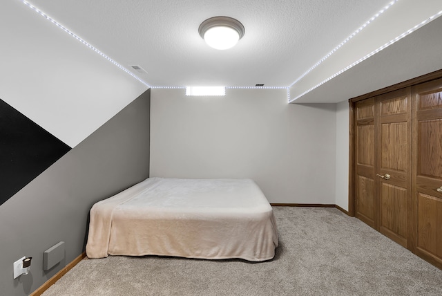 bedroom featuring light colored carpet and a closet