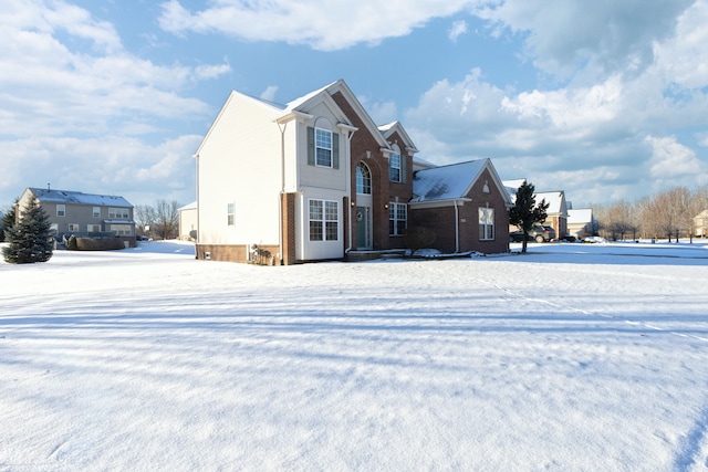 view of snow covered back of property