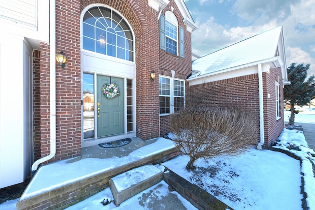 view of snow covered property entrance