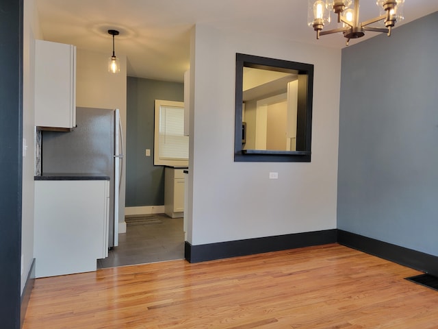 interior space featuring light hardwood / wood-style flooring and a notable chandelier