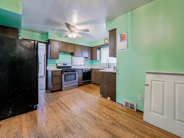 kitchen with dark brown cabinetry, ceiling fan, sink, light hardwood / wood-style floors, and black appliances