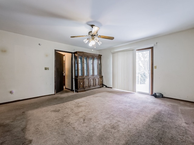 empty room featuring ceiling fan and carpet floors