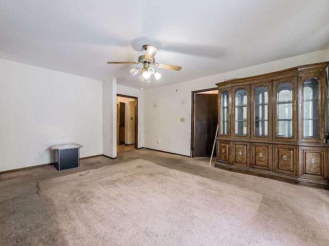 unfurnished room with ceiling fan and light colored carpet