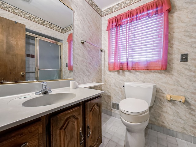 bathroom featuring tile patterned flooring, vanity, and toilet