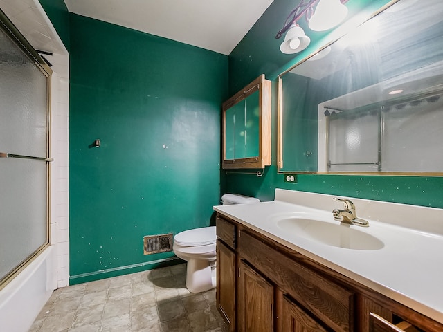 full bathroom featuring toilet, vanity, and combined bath / shower with glass door