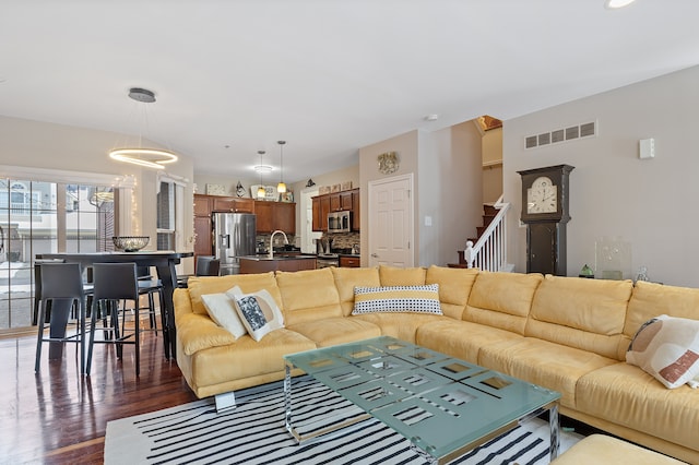 living room with sink and dark hardwood / wood-style floors