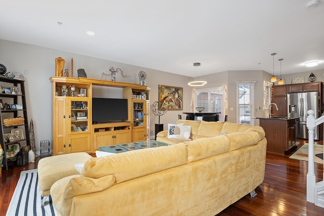 living room featuring sink and dark hardwood / wood-style flooring