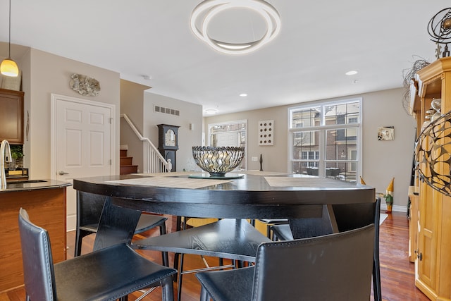 interior space with pendant lighting and hardwood / wood-style flooring