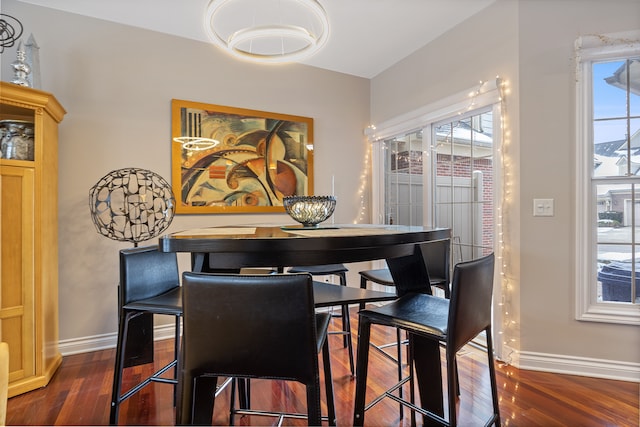 dining space with dark hardwood / wood-style flooring