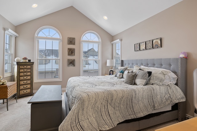 bedroom featuring light colored carpet and lofted ceiling