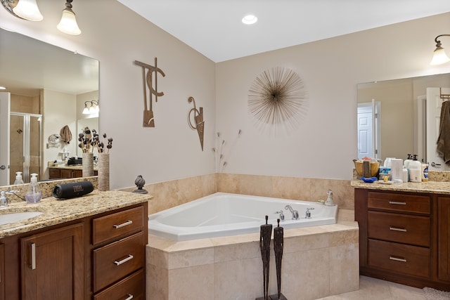 bathroom featuring tile patterned flooring, vanity, and shower with separate bathtub