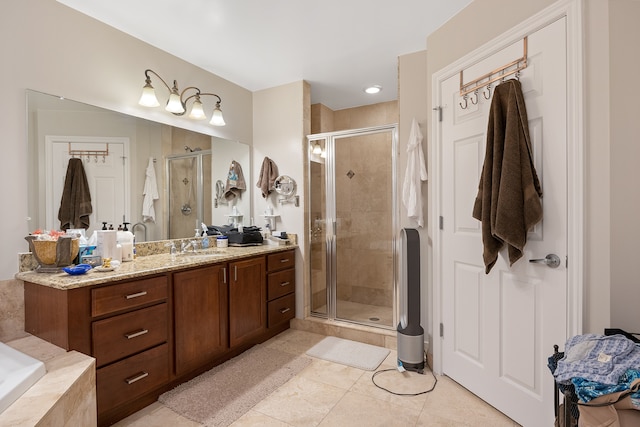 bathroom with tile patterned floors, a shower with shower door, and vanity