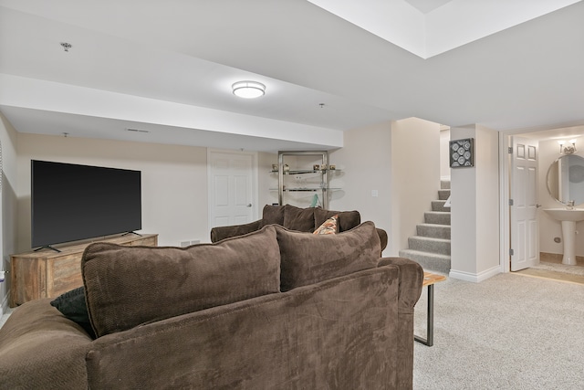 living room with sink and light colored carpet