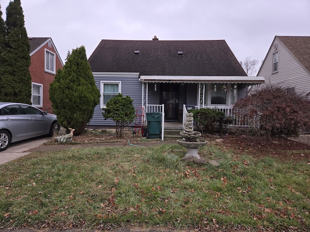 view of front of house with covered porch and a front yard