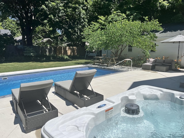 view of pool featuring outdoor lounge area, a patio area, and a yard