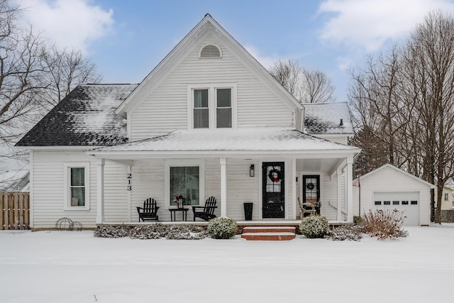 view of front of home with a porch, a garage, and an outbuilding