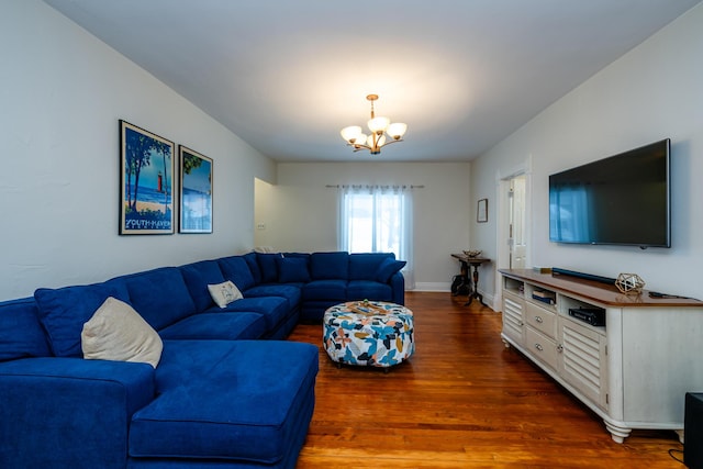 living room with dark hardwood / wood-style flooring and an inviting chandelier