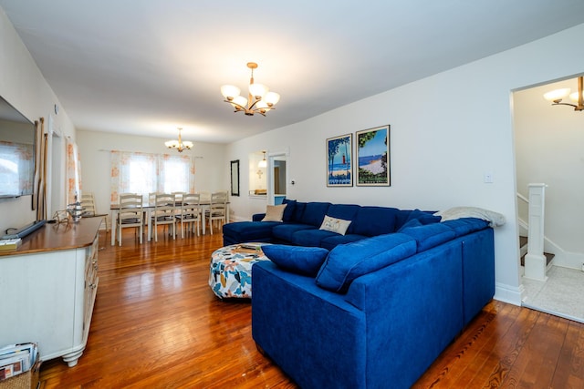 living room featuring dark hardwood / wood-style floors, an inviting chandelier, and a baseboard heating unit