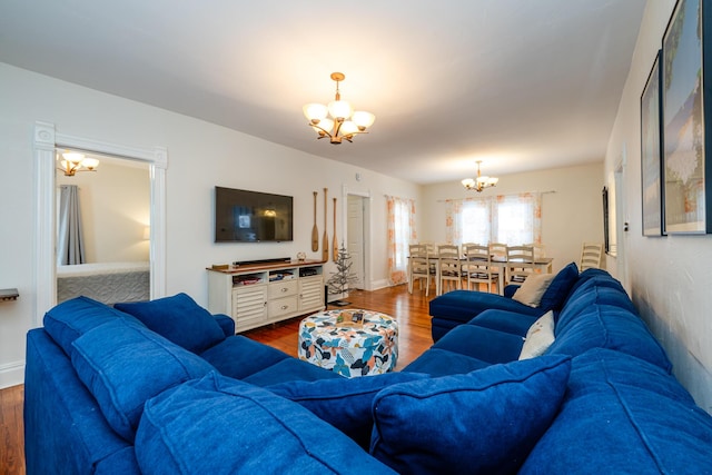 living room featuring hardwood / wood-style flooring and an inviting chandelier