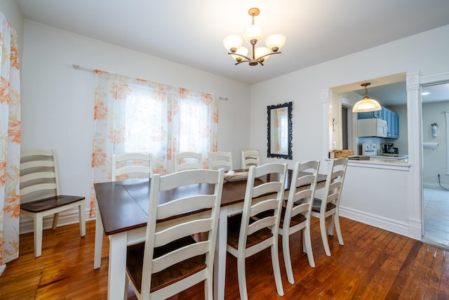 dining area featuring hardwood / wood-style flooring and a notable chandelier