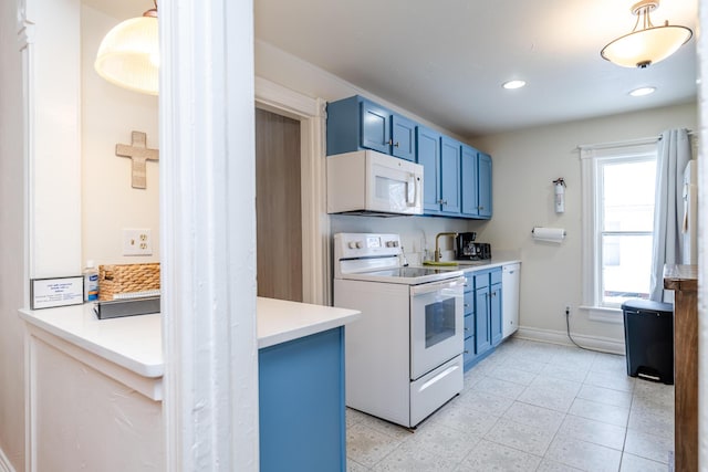 kitchen with white appliances and blue cabinets