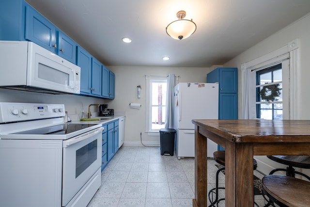 kitchen featuring sink, white appliances, and blue cabinets