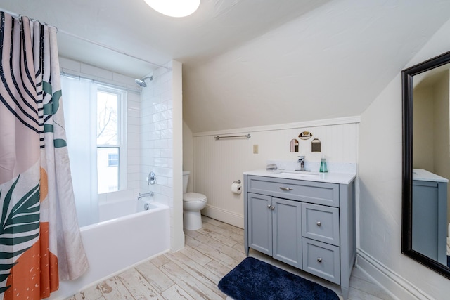 full bathroom featuring shower / bath combination with curtain, vanity, hardwood / wood-style floors, toilet, and lofted ceiling