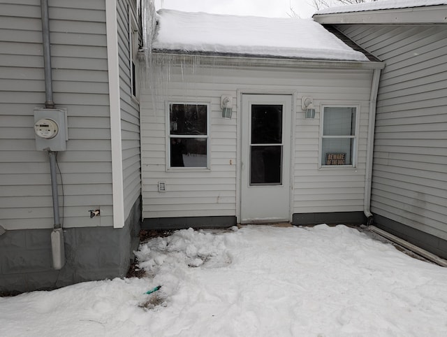 view of snow covered property entrance