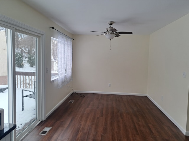 spare room with ceiling fan, plenty of natural light, and dark hardwood / wood-style floors