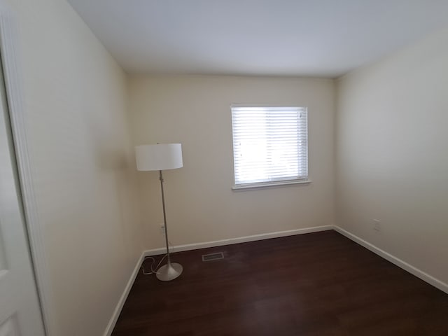 unfurnished room with dark hardwood / wood-style floors