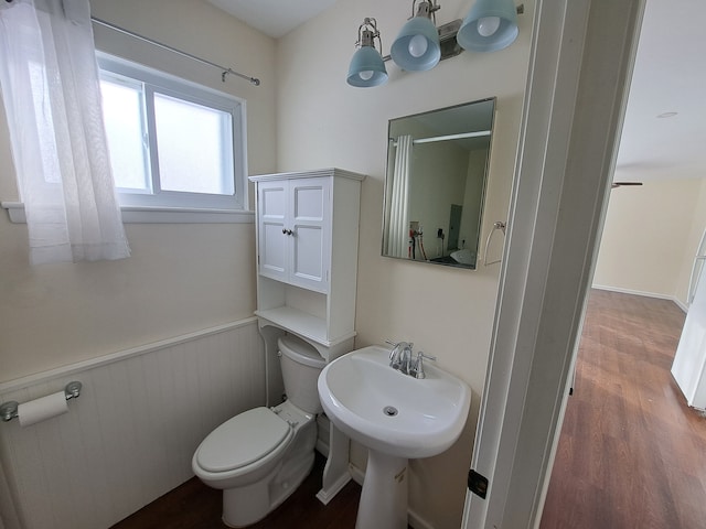 bathroom with toilet and hardwood / wood-style flooring