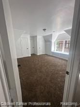 bonus room with dark colored carpet