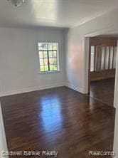 spare room with dark hardwood / wood-style flooring