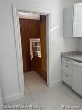 kitchen with white dishwasher and white cabinets