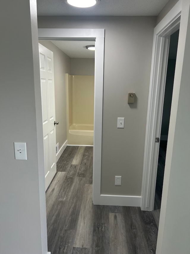 corridor featuring dark wood-type flooring