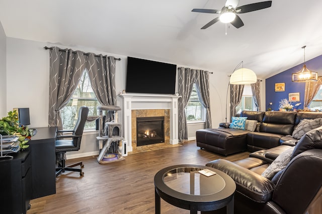 living room with a tile fireplace, dark hardwood / wood-style flooring, and plenty of natural light