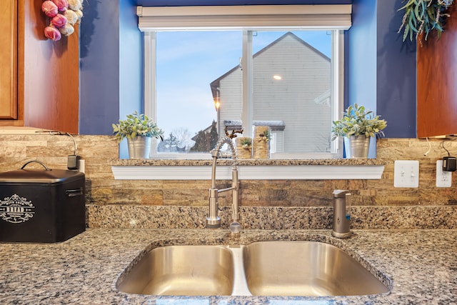 room details with backsplash and light stone countertops