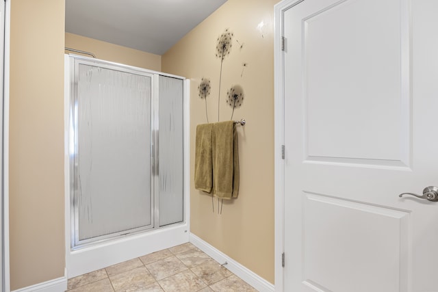 bathroom featuring a shower with door and tile patterned floors