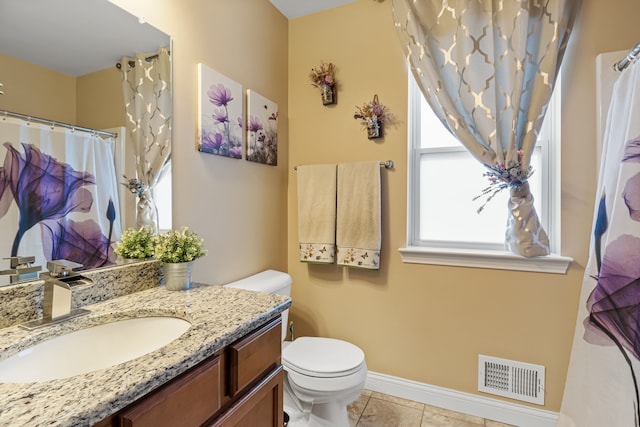 bathroom with tile patterned flooring, vanity, and toilet