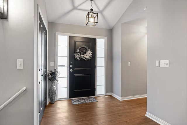 foyer featuring lofted ceiling and dark hardwood / wood-style flooring