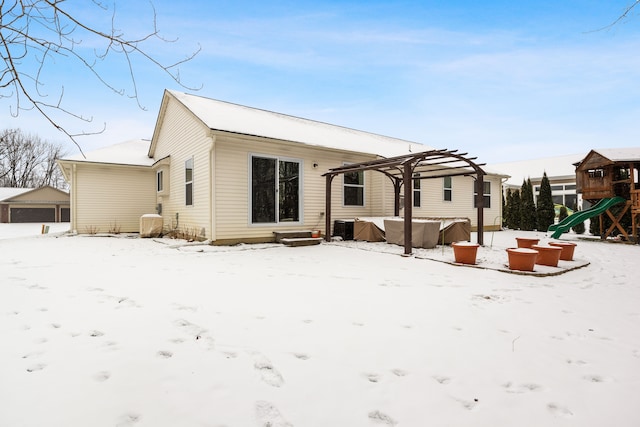 snow covered property featuring a playground and a pergola