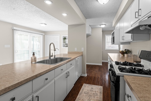 kitchen featuring white cabinetry, gas stove, dishwasher, a textured ceiling, and sink