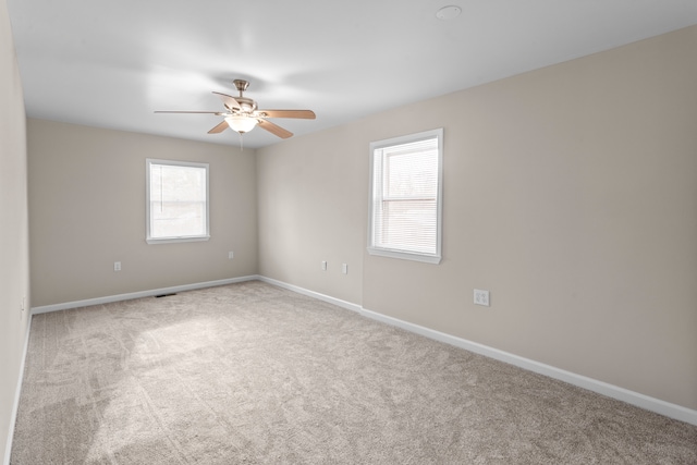 spare room with light carpet and ceiling fan