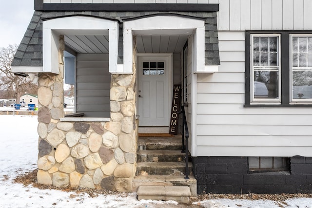 view of snow covered property entrance